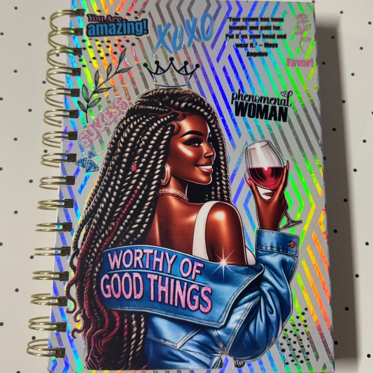 Notebook with a colorful design featuring a woman holding a glass of wine, text, and a polka dot background.